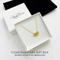 Five gold rings necklace in gift box ready to be gifted to her for her birthday. KookyTwo.