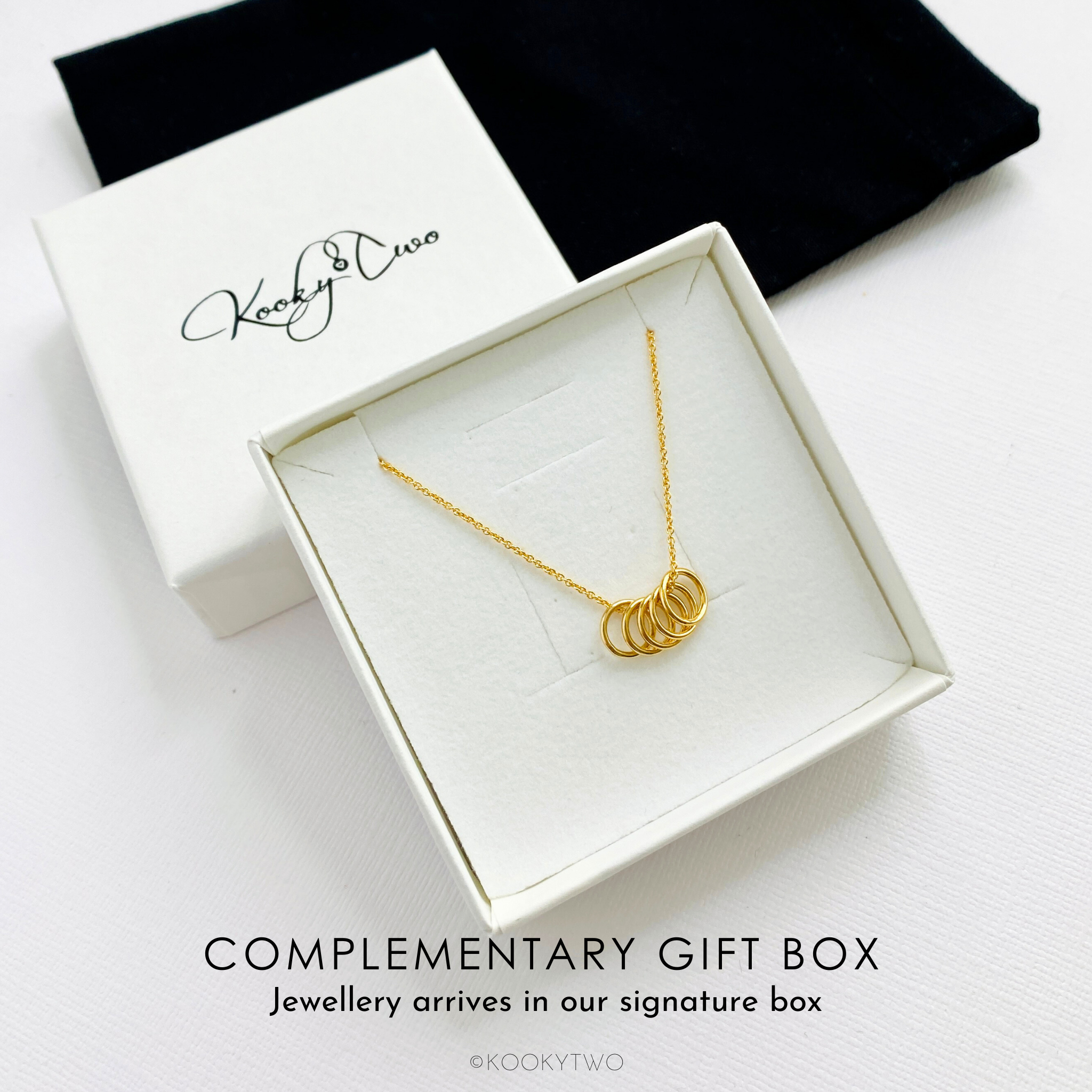 Five gold rings necklace in gift box ready to be gifted to her for her birthday. KookyTwo.
