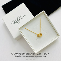 Four gold rings necklace in gift box ready to be gifted to her for her birthday. KookyTwo.