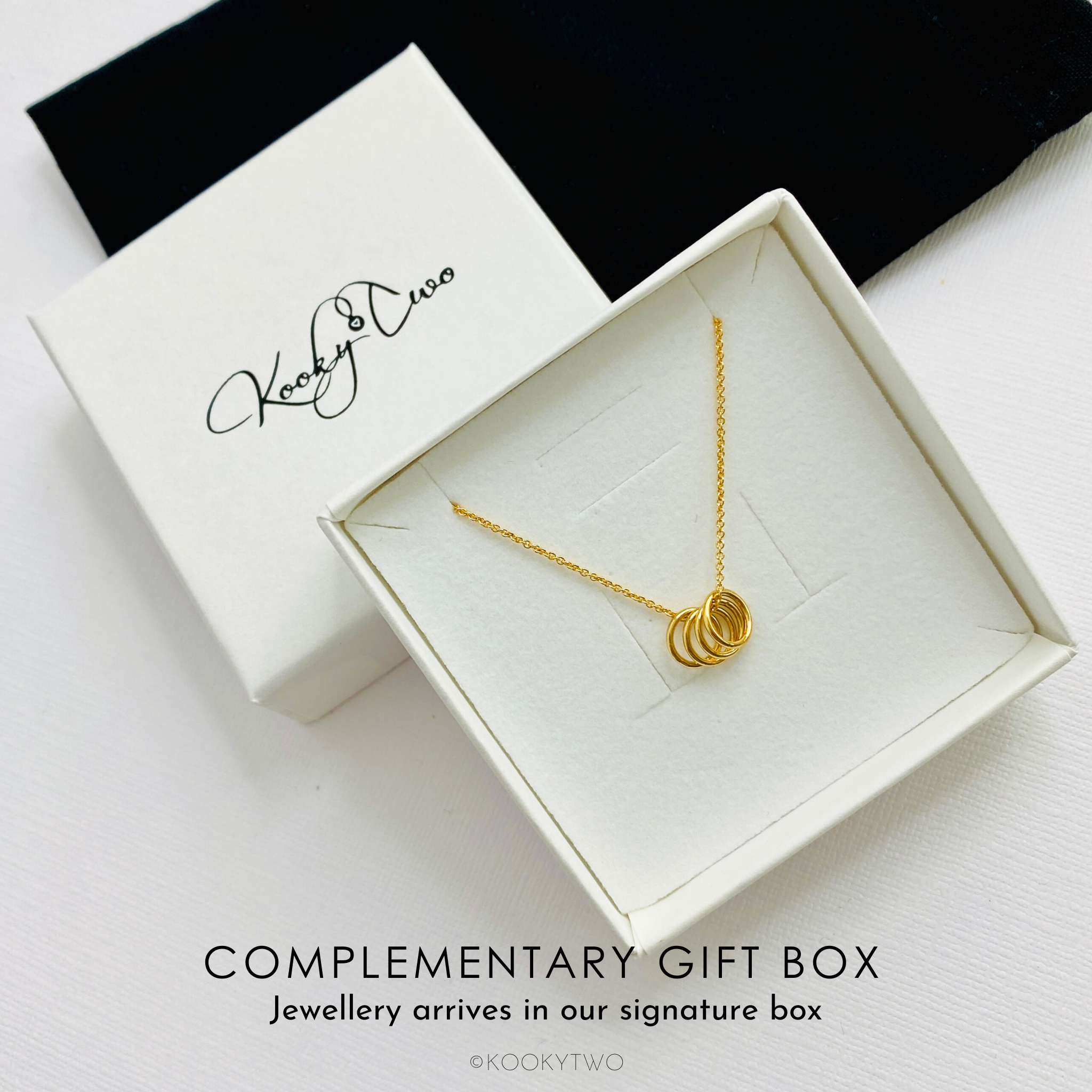 Four gold rings necklace in gift box ready to be gifted to her for her birthday. KookyTwo.