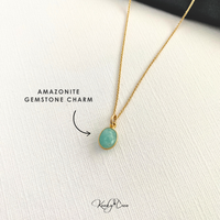 Gold necklace with an Amazonite gemstone charm on a white background