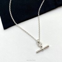 On trend T bar necklace in sterling silver on background to show the high-quality materials and contemporary design. KookyTwo.