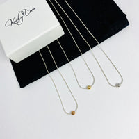 Silver necklaces with a singular bead, available in rose gold, gold and silver. Kooky Two.
