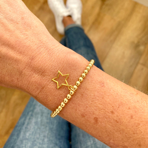 Handmade gold bead bracelet with gold star pendant. 