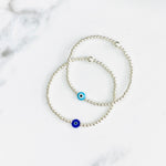 Nazar evil eye bracelets with silver beads and blue evil eye beads.