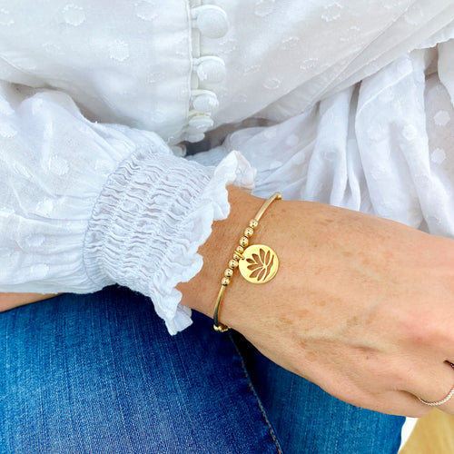 Gold bracelet with lotus flower charm. Bracelet for someone who loves yoga with lotus flower charm. Zen bracelet.