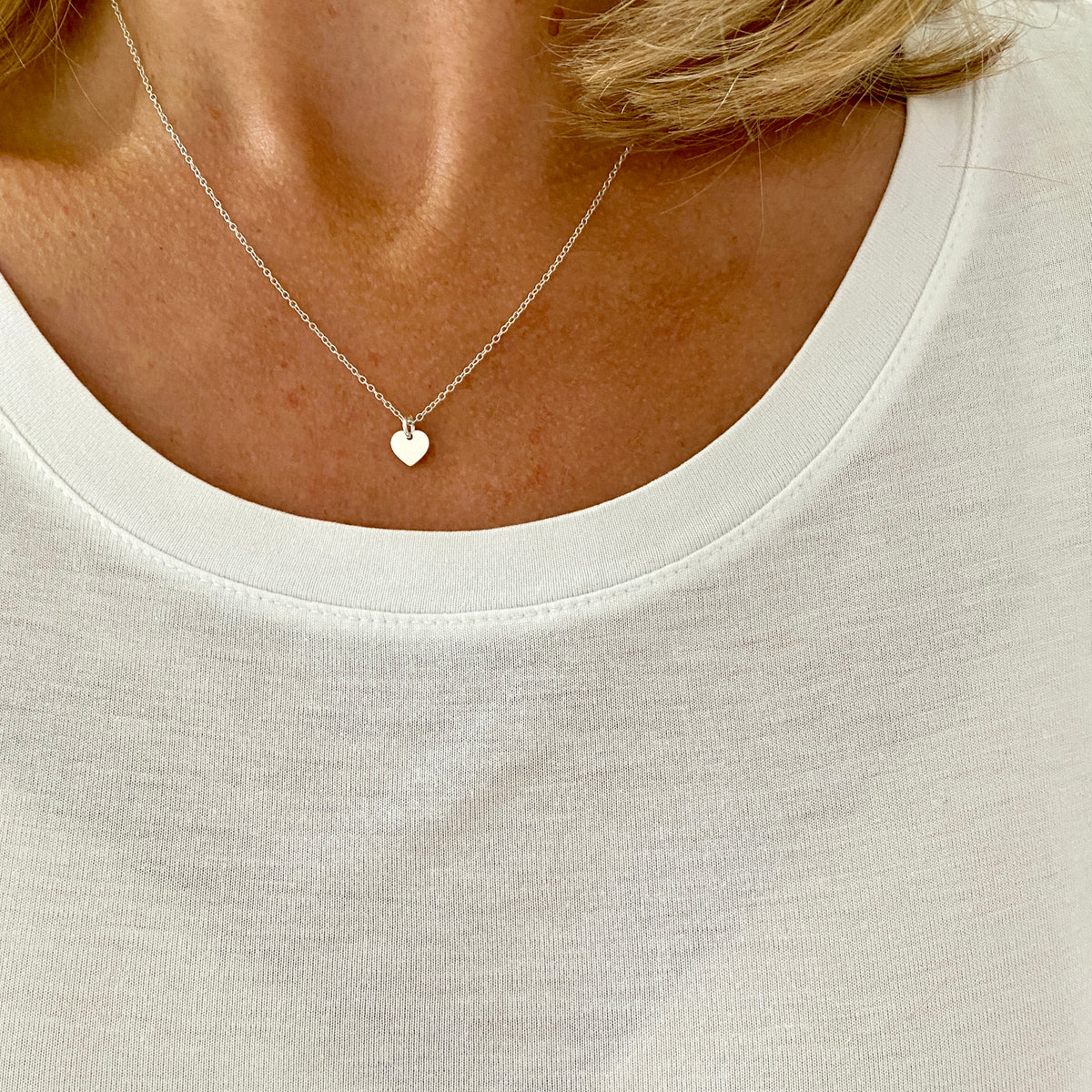 Minimalist silver heart necklace.