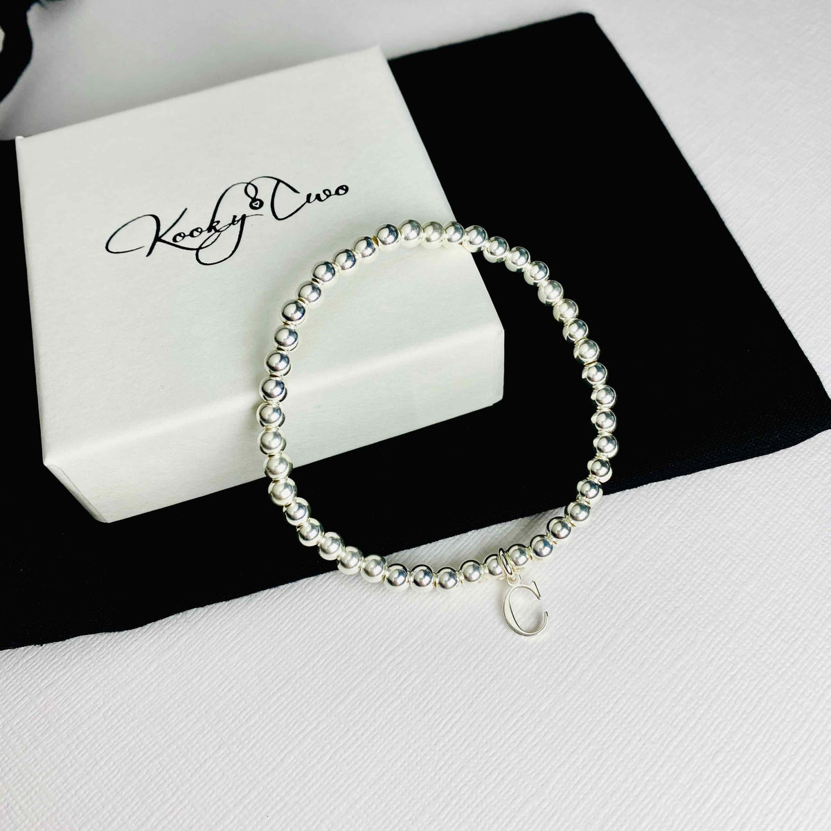 Sterling silver initial bracelet with silver letter charm. KookyTwo.