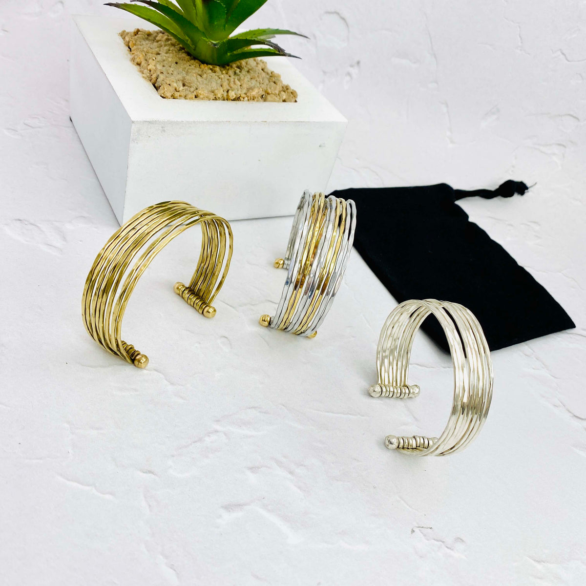 Chunky bangle bracelets with an adjustable fit. Silver and gold cuff bangles.