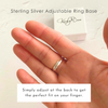 Hand wearing a silver adjustable ring base with packaging in the background.