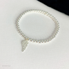 Pretty Sterling silver beaded bracelet with  a dainty angel wing charm, symbolising love and protection. KookyTwo.