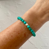 A stunning turquoise bracelet adorning a wrist, the perfect colourful accessory for everyday wear.