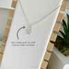 Minimalist sterling silver hamsa hand necklace with a dainty chain, ideal for layering or a subtle everyday look. KookyTwo.