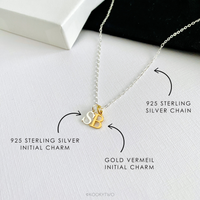 Necklace with 925 sterling silver chain, with sterling silver initial charm  and gold vermeil initial charm on a white background.