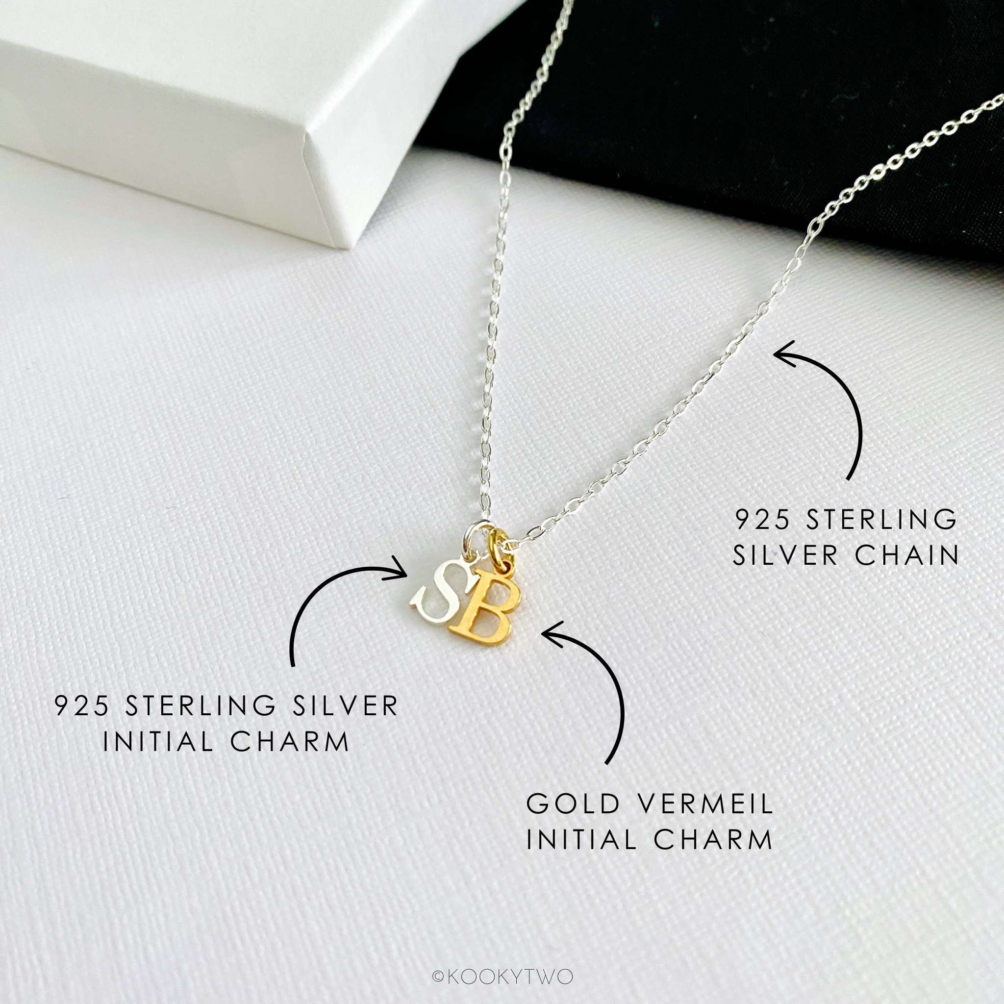Necklace with 925 sterling silver chain, with sterling silver initial charm  and gold vermeil initial charm on a white background.