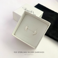 925 Sterling Silver Feather Stud Earrings in a box with KookyTwo branding.