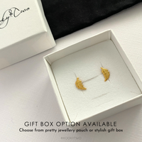 Gold feather earrings in a white box with 'KookyTwo' branding.