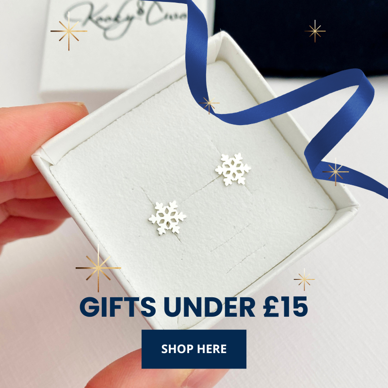 Snowflake earrings in a box with a hand holding it, promotional text for gifts under £15.