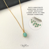 Gold necklace with a green gemstone pendant on a white background, with text about Amazonite gemstones.