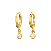 A pair of gold huggie hoop earrings with a small round clear gemstone dangling below each hoop, shown on a plain white background.