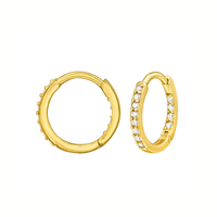 A pair of gold huggie hoop earrings, one shown from the front with a row of clear pavé-set stones and the other from the side showing the beaded edge and clasp mechanism, on a solid white background.