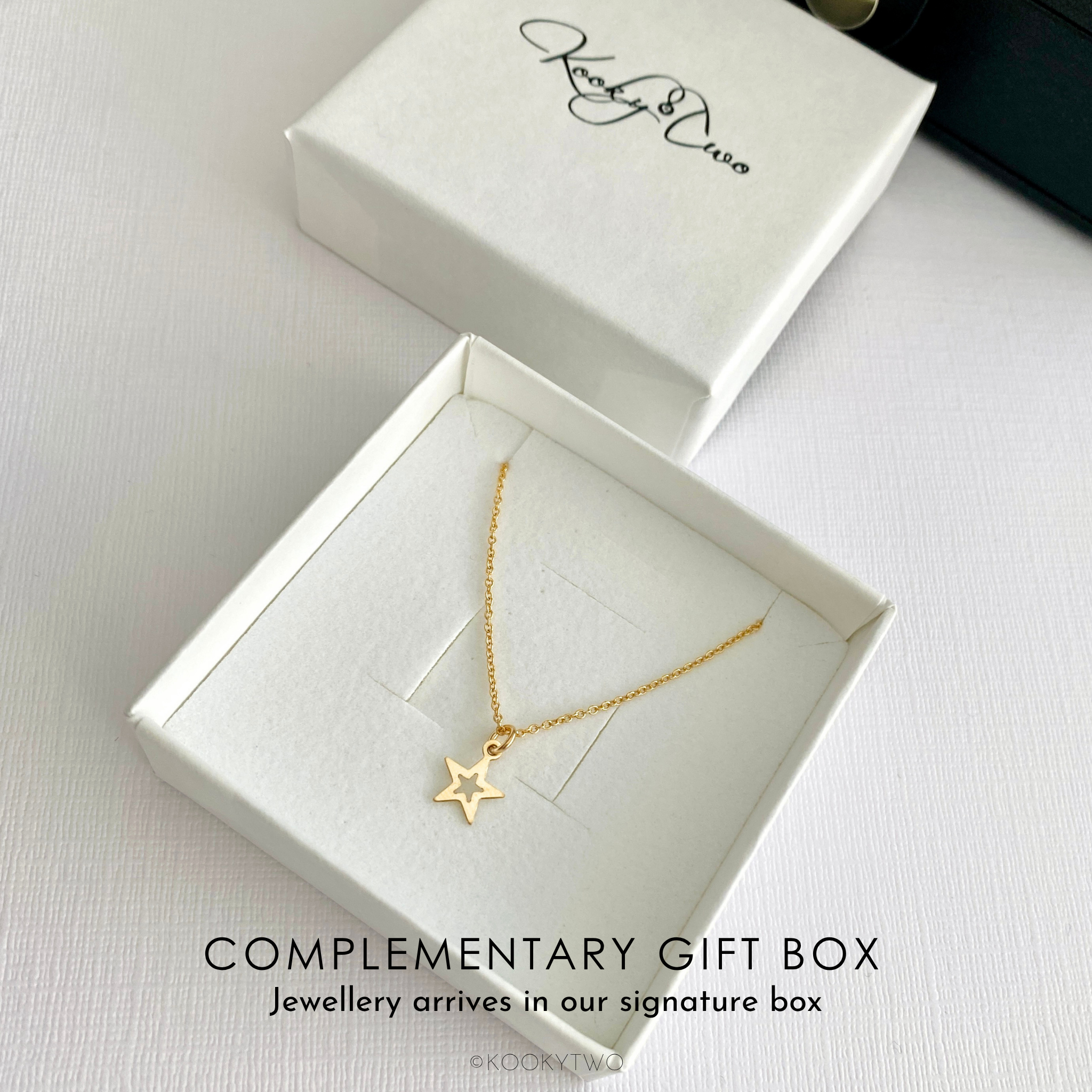 Gold star necklace in a white gift box with 'KookyTwo' branding.