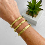 Summer jewellery styling with gold cuff bangle featuring three bars with a hammered effect. KookyTWo