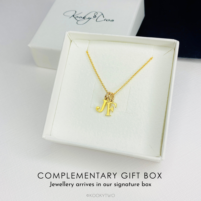 Letter necklace gift for women with gold letter charms on gold chain.