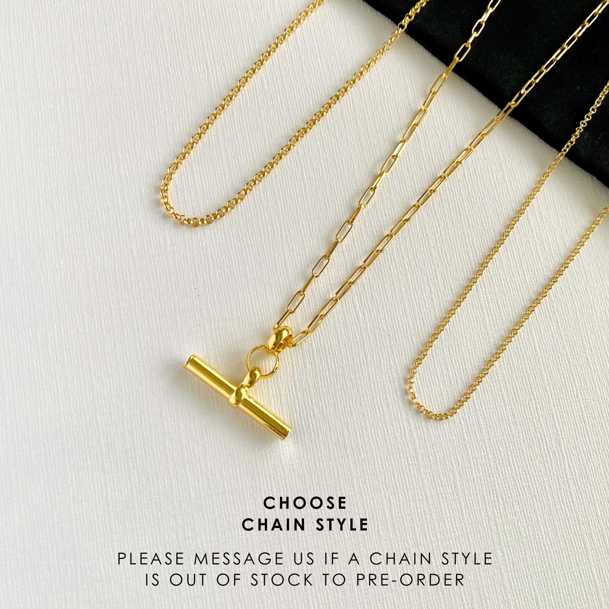 A bold and stylish eye-catching gold t bar charm necklace. Shown against a white background to showcase its modern and elegant look, perfect for everyday wear.