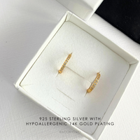 Hypoallergenic gold huge earrings with crystals in a white gift box.