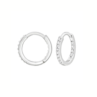 A pair of silver huggie hoop earrings, one plain and one set with small clear stones, shown on a solid white background.