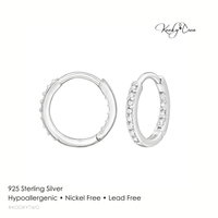 Pair of silver hoop earrings with clear stones on a white background, featuring Kookytwo branding.