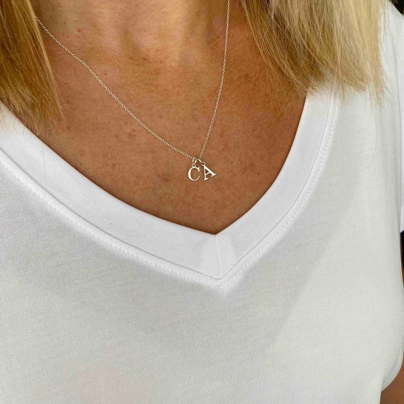 Letter necklace with two Letter necklace with silver initial charms on chain. KookyTwo
