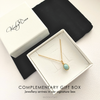 Jewellery box with a gold necklace featuring a blue pendant, branded 'KookyTwo'.