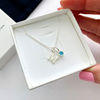 A stunning initial charm and aquamarine birthstone necklace, the perfect gift for March birthdays as aquamarine represents the birthstone for March birthdays. KookyTwo.