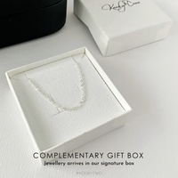 A sterling silver chain necklace displayed inside an open white gift box with a textured insert, alongside a closed white box with a black script logo KookyTwo. Text at the bottom reads 'COMPLEMENTARY GIFT BOX' and 'Jewellery arrives in our signature box'.