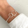 Mother and daughter bracelet with two silver interlocking circles. KookyTwo.