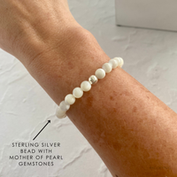 A beautiful mother of pearl gemstone bracelet glowing softly on a wrist. Elegant and timeless bracelet, perfect for everyday wear.