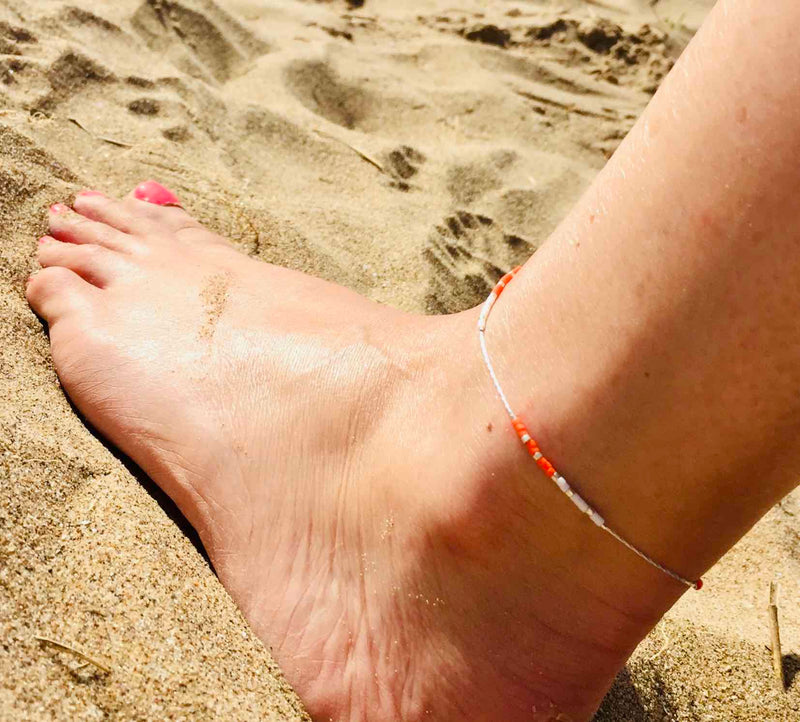 Orange bead anklet with small beads for beach days. KookyTwo.