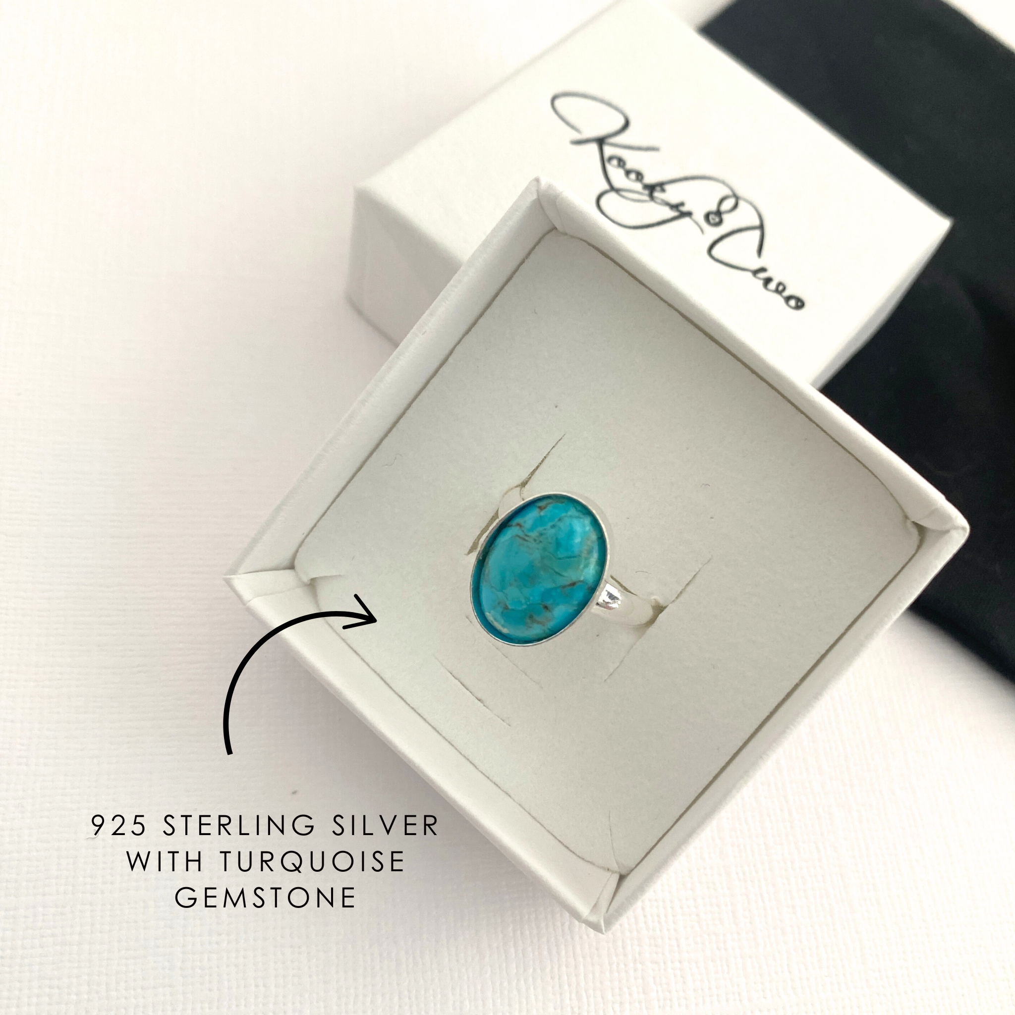 Turquoise gemstone silver ring in a white gift box.