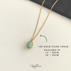 Gold filled necklace with a oval Larimar pendant on a white surface, featuring text about chain length.