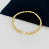 Bridal bracelet with 14k gold filled beads and single pearl bead. KookyTwo.