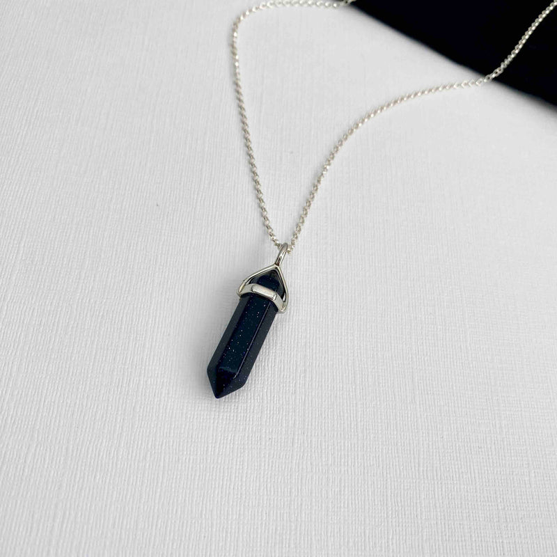 Deep blue goldstone point pendant necklace. Pendant features sparkly flecks that catch in the light. KookyTwo.