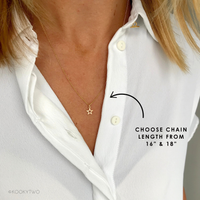Gold necklace with a star pendant on a white shirt, labeled for chain length options.