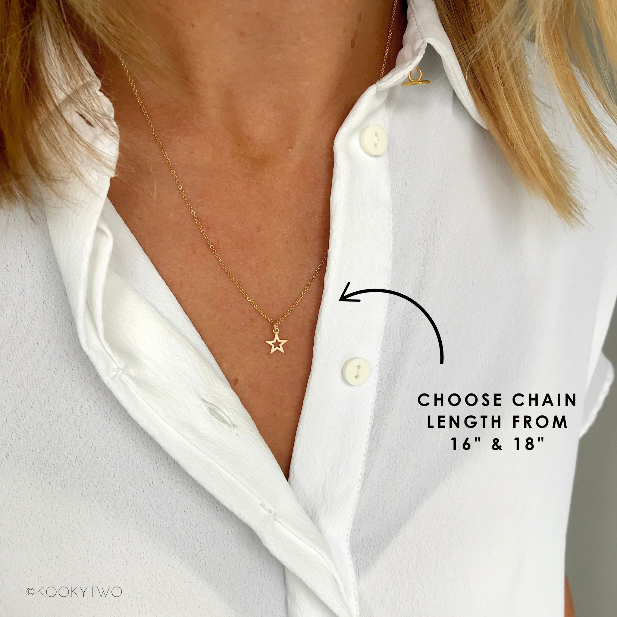 Gold necklace with a star pendant on a white shirt, labeled for chain length options.