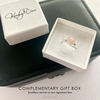 Rose quartz silver ring in a white box with KookyTwo branding. Rose quartz gemstone ring sits on a black jewellery box.