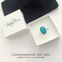 Turquoise ring in a white box with Kookytwo branding on a light background