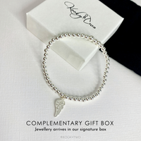 Stylish and elegant sterling silver bead bracelet with a delicate angel wing charm, perfect for everyday wear or gifting. KookyTwo.