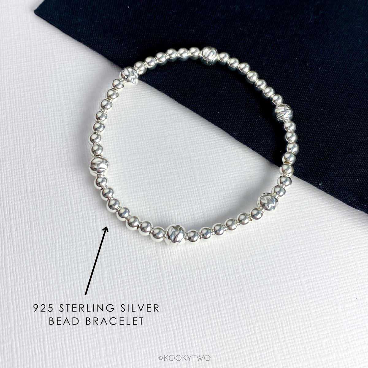 A dainty and stylish sterling silver bead bracelet worn perfect for bracelet stacking or wearing solo. KookyTwo.