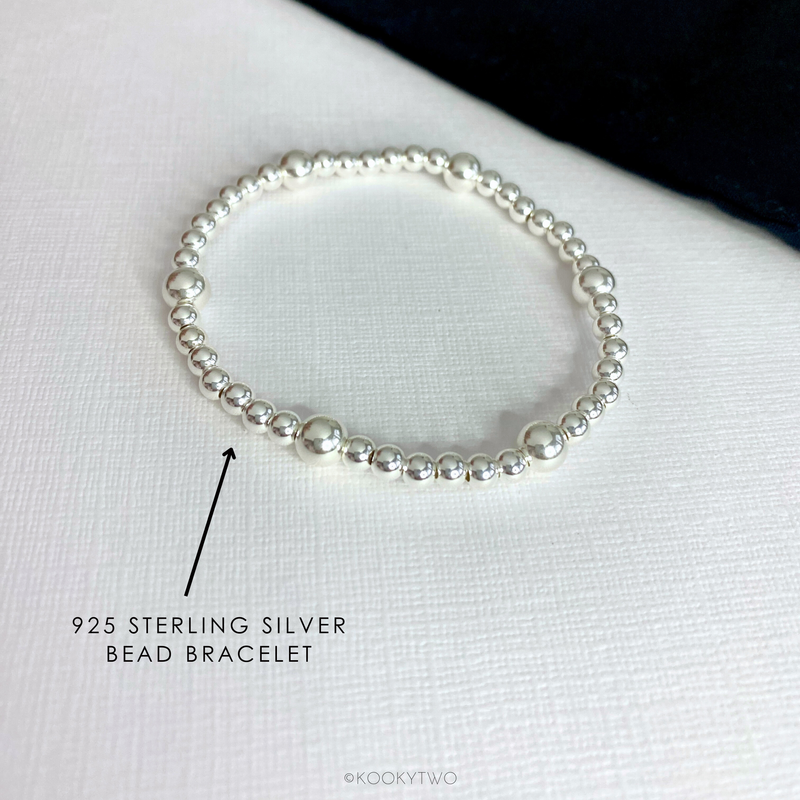 Close-up of a simple sterling silver bead bracelet, showcasing its sleek and timeless design.